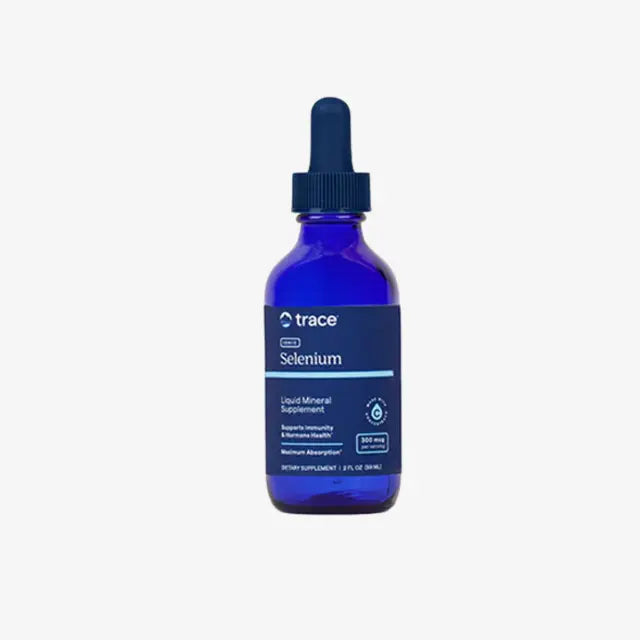 Blue bottle of trace Selenium supplement with dropper on a white background