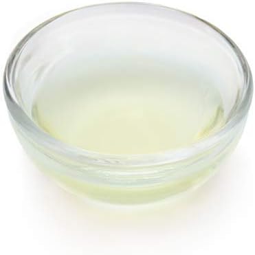 Clear glass bowl with a white liquid on a white background