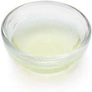 Clear glass bowl with a white liquid on a white background