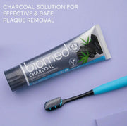 BIOMED Black Charcoal Toothbrush & toothpaste, medium bristles, on a clean background.