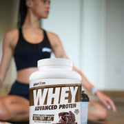 Whey protein supplement container with a person in the background