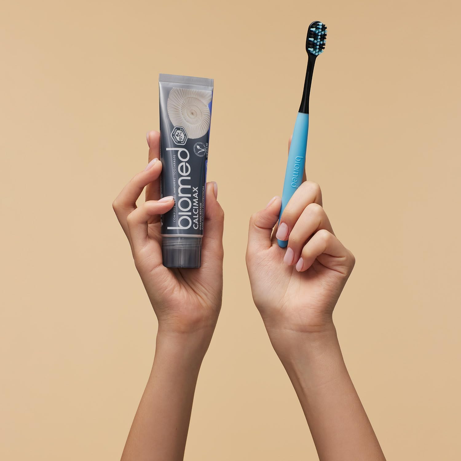 BIOMED Black Charcoal Toothbrush & calcimax toothpaste, medium bristles, on a clean background.