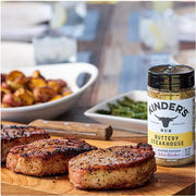 Lifestyle/use image: Kinder's Buttery Steakhouse Seasoning used on steak and vegetables 295g