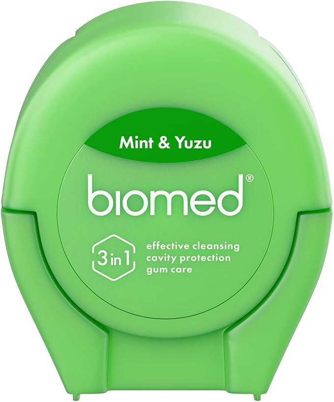BIOMED Mint and Yuzu flavored dental floss dispenser on a clean background.