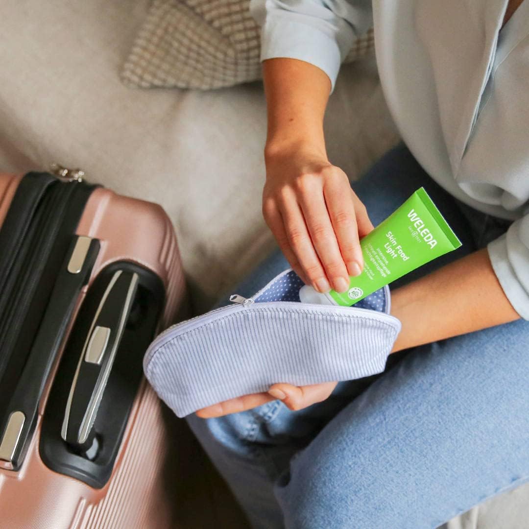 Weleda Skin Food Light moisturising cream applied to face and body 75ml travel 