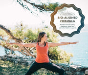 Woman practicing yoga outdoors with a natural background and a supplement label overlay.