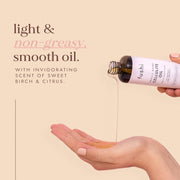 Fushi body oil being poured onto a hand with text about the product on a beige background