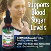 Bottle of Natures Answer Cinnamon Bark fluid extract with a woman exercising in the background, text about product benefits.