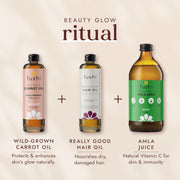 Fushi beauty products including carrot oil, hair oil, and amla juice on a beige background.