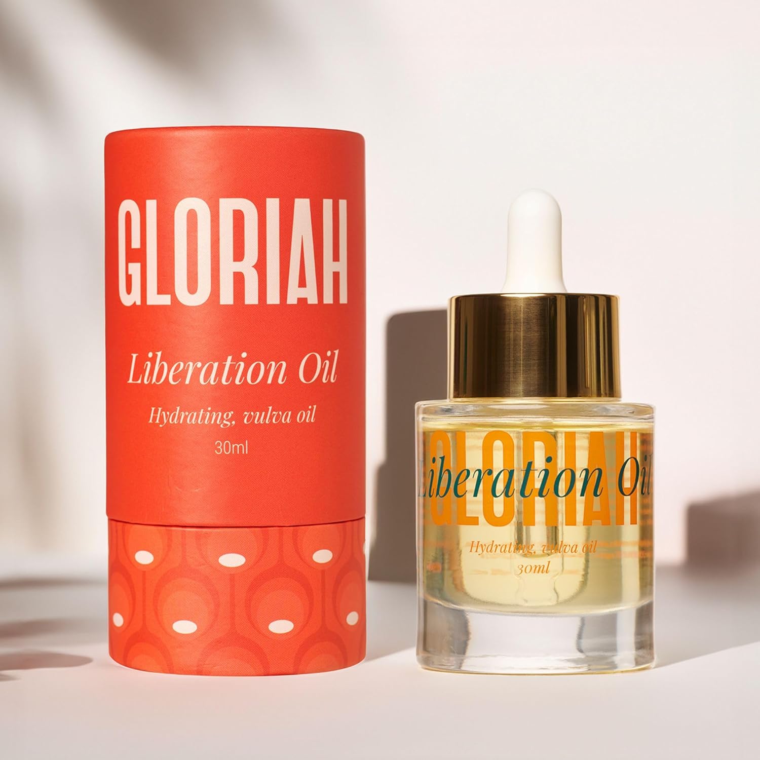Gloriah Liberation Oil packaging with red container and dropper bottle on a light background