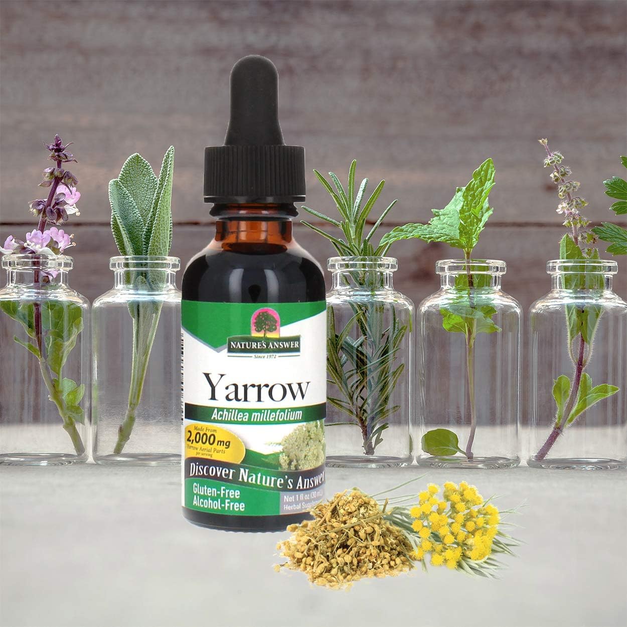 Yarrow extract bottle with plants and flowers on a neutral background