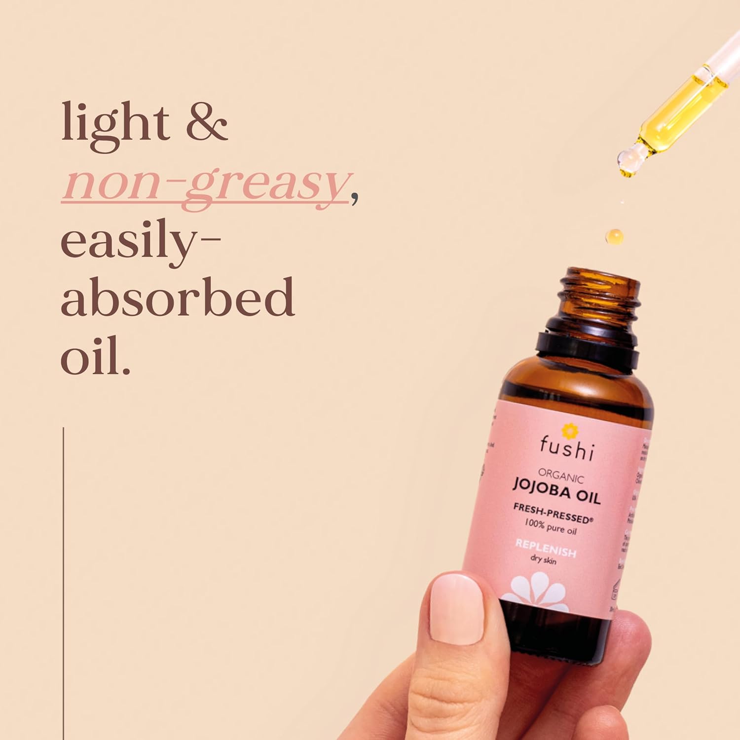 Fushi organic jojoba oil bottle with dropper on a beige background