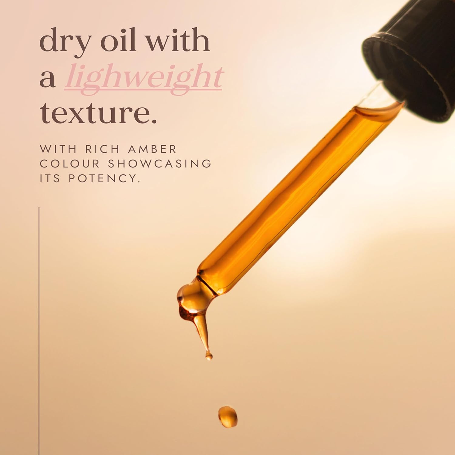 Amber oil dropper with oil dripping against a beige background