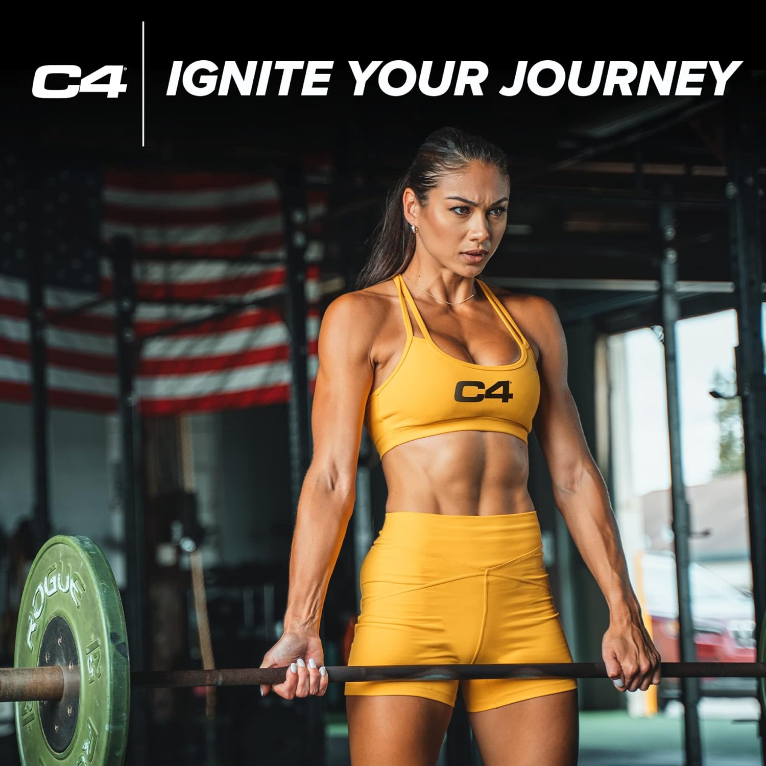 Woman in yellow C4 sports attire lifting weights with an American flag in the background