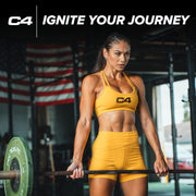 Woman in yellow C4 sports attire lifting weights with an American flag in the background