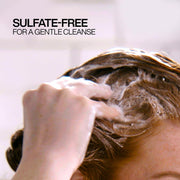 Redken Shampoo being lathered in wet hair.