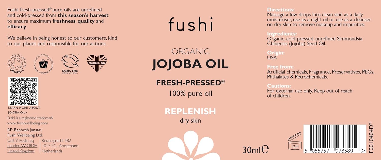 Fushi Organic Jojoba Oil packaging with text and branding on a pink background