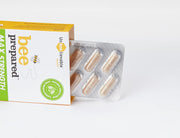 Bee Prepared capsule next to a glass of water on a white background.