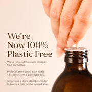 Brown bottle with a hand holding a dropper, text about plastic-free policy.