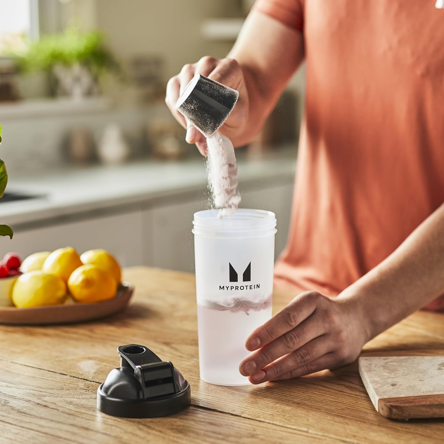 How to Use: Shaker bottle with Myprotein Clear Whey Isolate powder pouring.