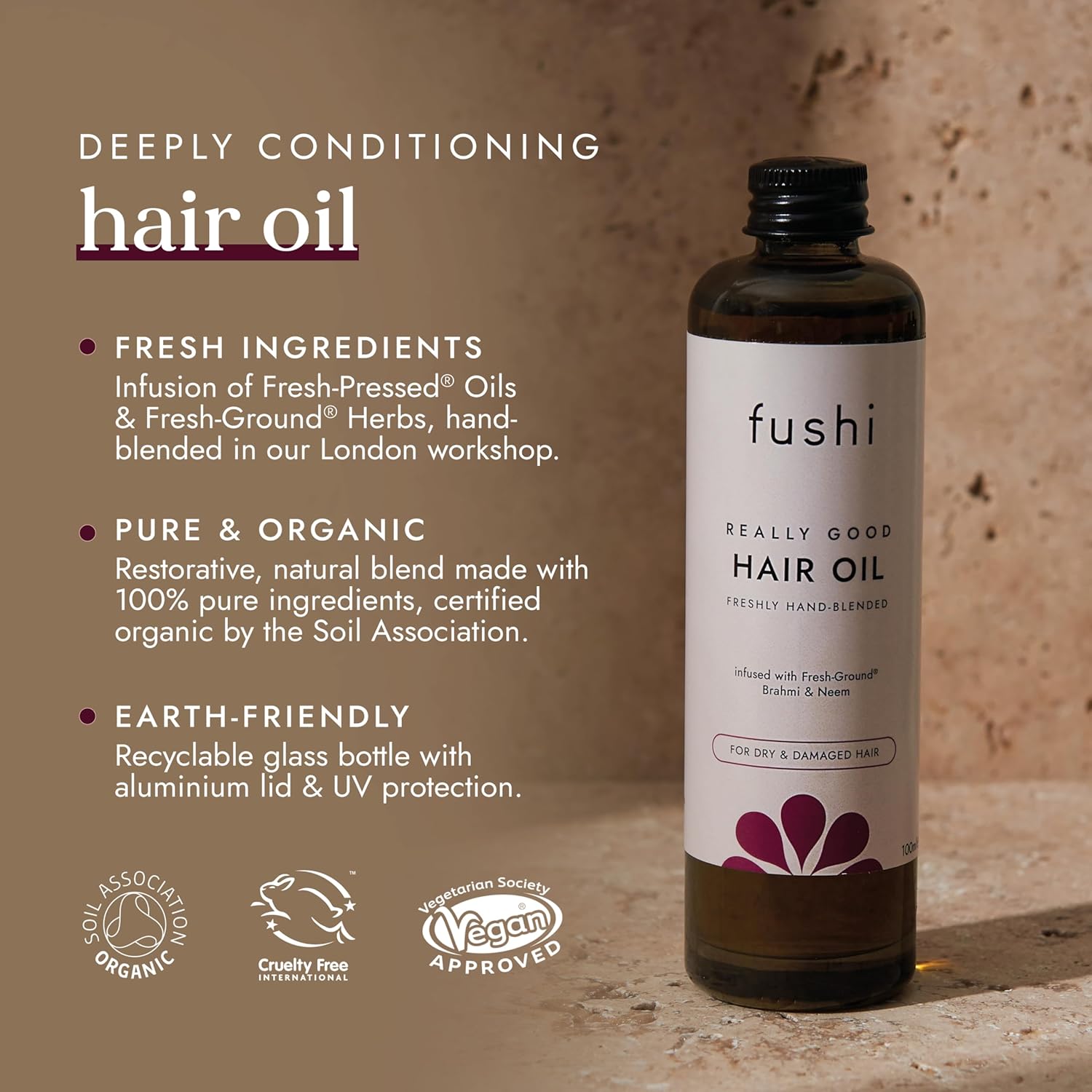 Fushi hair oil bottle with product details on a textured background