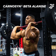 Muscular man lifting weights with Carnosyn Beta Alanine branding above.