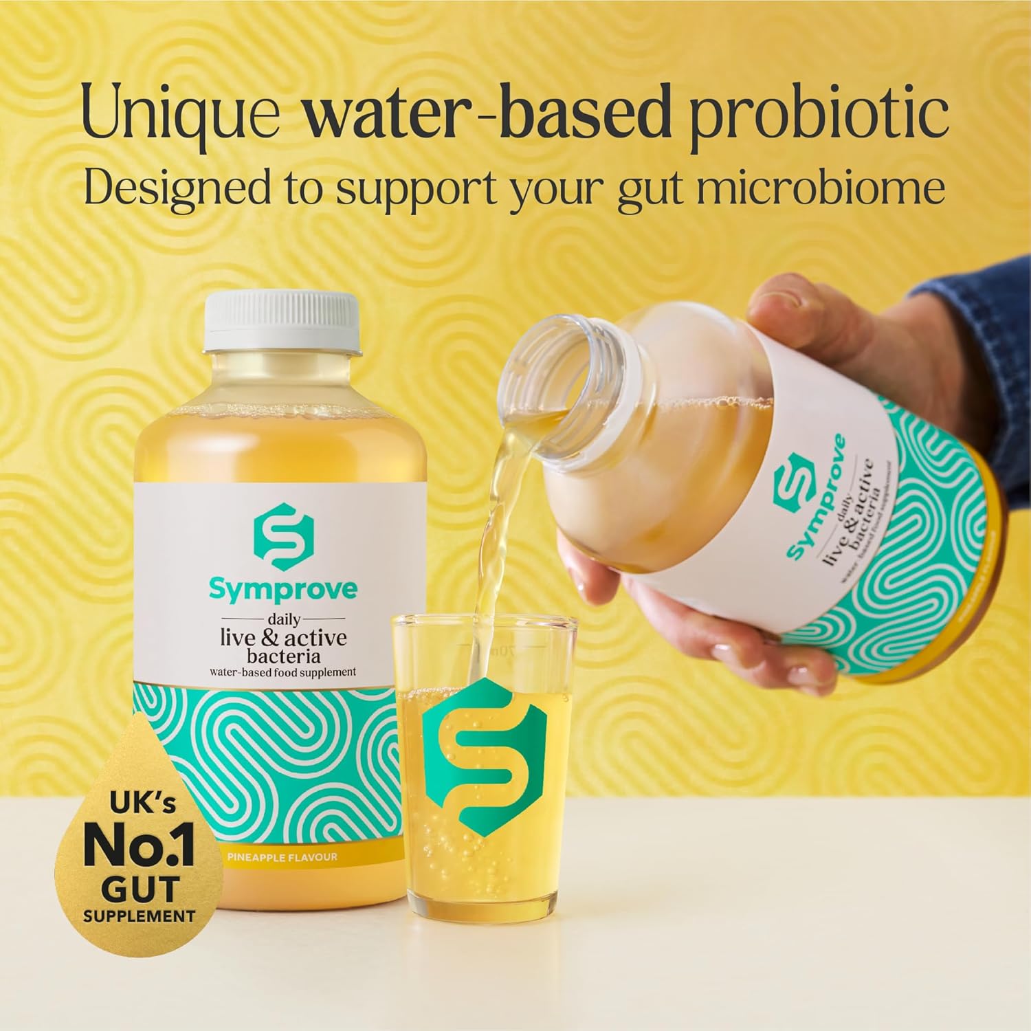 Symprove probiotic product being poured into a glass with a yellow background