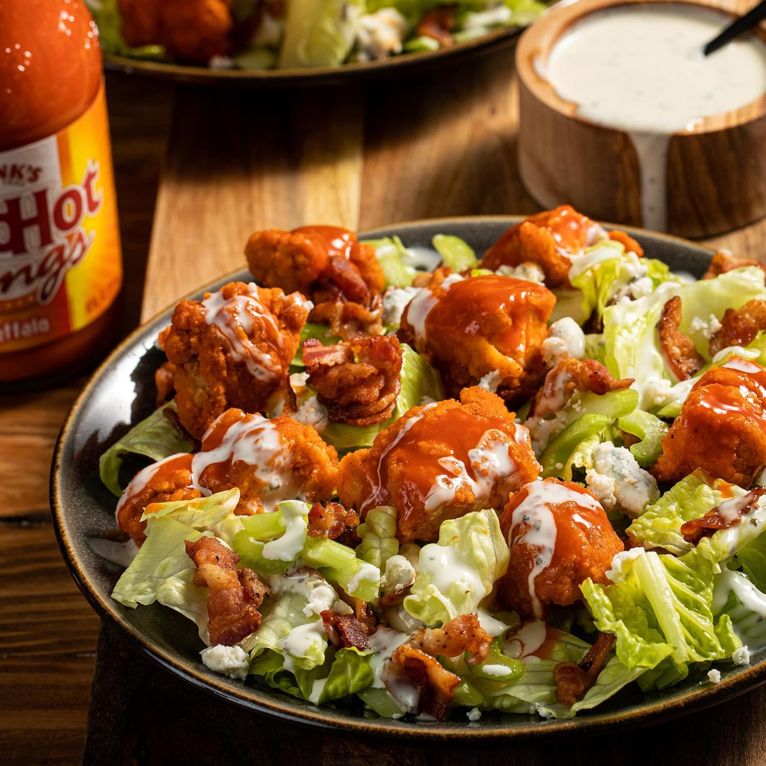 Lifestyle/use image: Franks RedHot buffalo sauce used on wings and food bottle 680ml