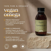 Bottle of fushi Flaxseed Oil on a stone surface with product details on a brown background