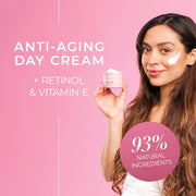 Woman holding an anti-aging day cream with retinol and vitamin E on a pink background