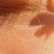Close-up of skin with a 'Glowy, Skin-Kissed Complexion' label.