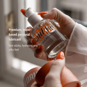 Hand holding a bottle of 'LORI' personal lubricant with product details text.