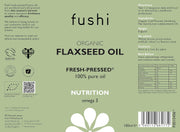 Label of fushi Organic Flaxseed Oil with text and symbols on a green background