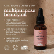 Bottle of fushi organic castor oil with product details on a wooden background
