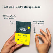 One small vegan turmeric tablets in hand, easy to swallow.