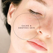 Close-up of a person's face with text 'Calm & Soothe Skin' on a neutral background