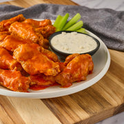 Lifestyle/use image: Franks RedHot buffalo sauce used on wings and food bottle 680ml
