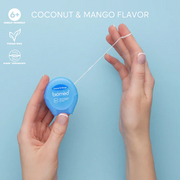 Close-up of BIOMED Coconut and Mango flavoredfloss stretched between fingers.