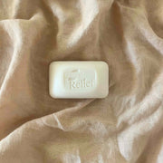 Bar of soap with 'Hope for Relief' branding on a beige fabric background