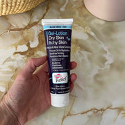 Hand holding a tube of Gel-Lotion on a marble surface