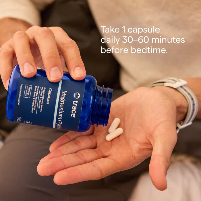 Person holding a blue supplement bottle with capsules in their hand, and text on how to take the supplement.