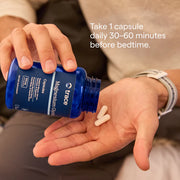 Person holding a blue supplement bottle with capsules in their hand, and text on how to take the supplement.