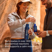 Two people outdoors, one holding a blue bottle labeled 'trace' and the other holding a phone.