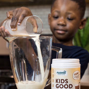 Kids Good Stuff chocolate powder being mixed into a child's drink.