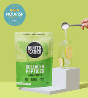 Hunter and Gather collagen peptides packaging with a person adding powder to lemon water on a green background.