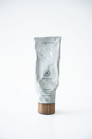 Skincare product with wooden applicator on a white background