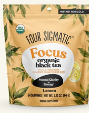 Four Sigmatic Focus organic black tea package with lemon flavor on a beige background