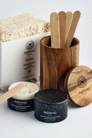 Re[Sens] skincare products with wooden containers and spoons on a white background