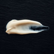 White cream smear on a black background