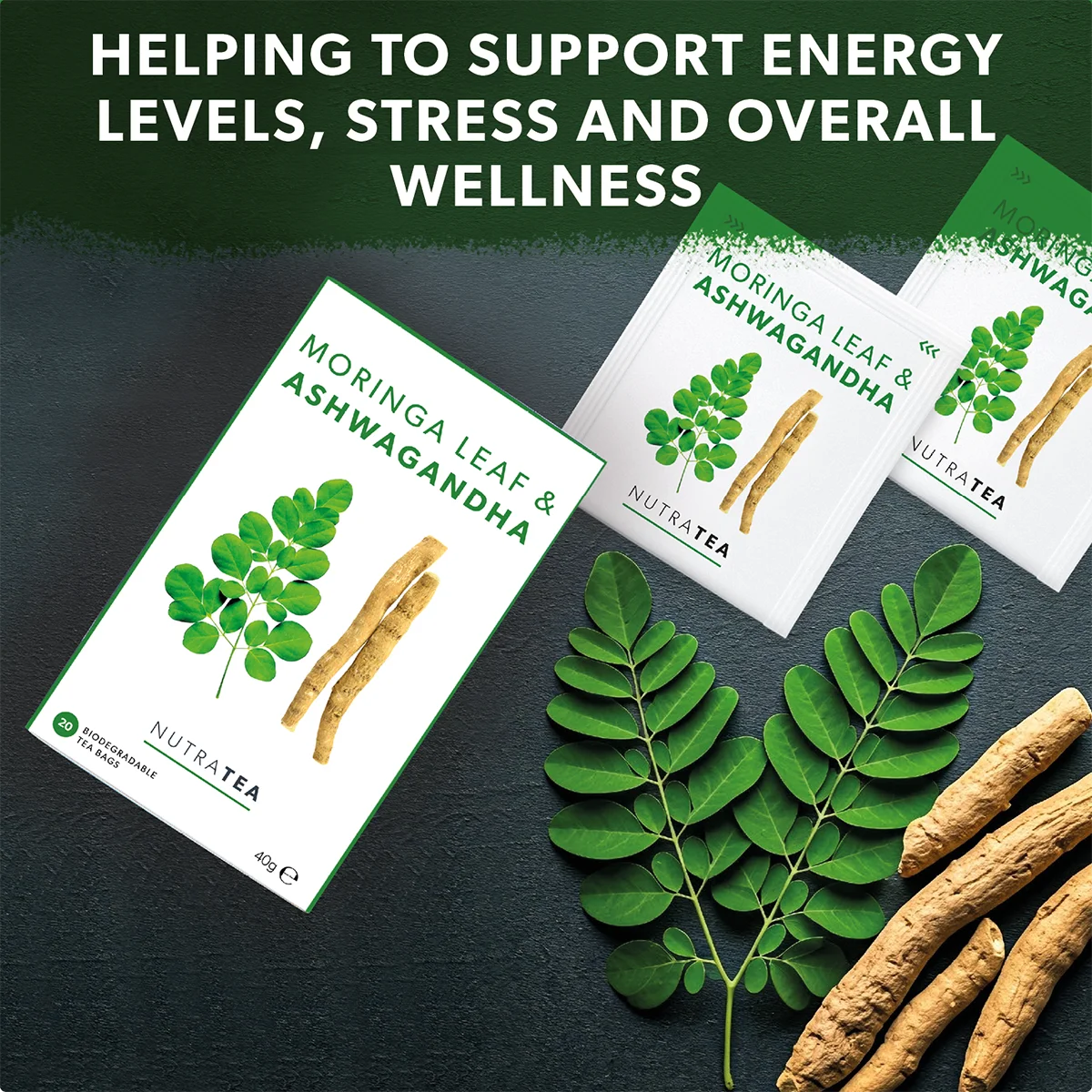 Moringa Leaf Ashwagandha tea packages with leaves and roots on a dark surface, promoting energy levels and wellness.